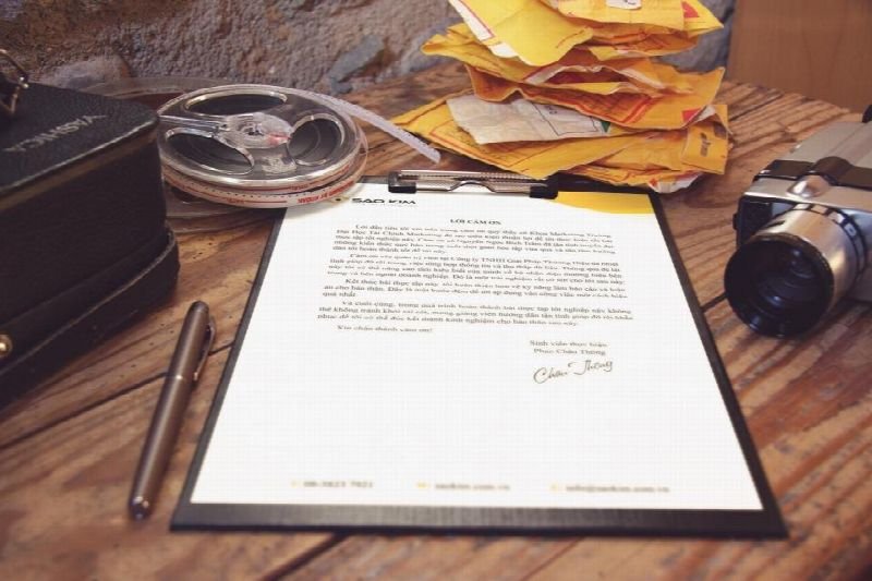 Printed document on a clipboard on a wooden desk