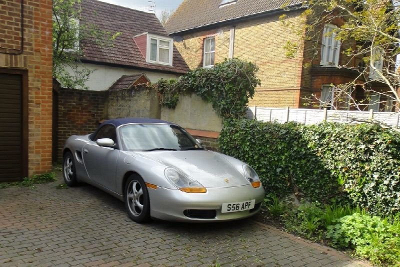Silver sports car parked in a house driveway