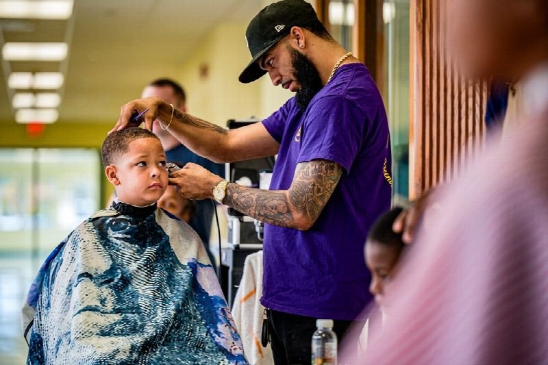 Barber giving a customer a haircut