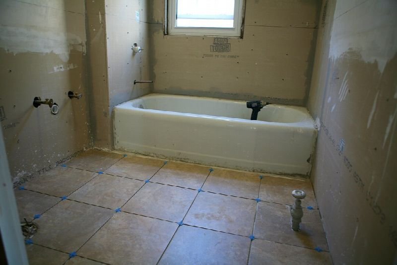 Bathroom with a new bathtub and tiled floor