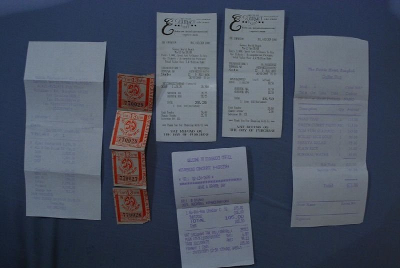 Receipts and paper slips pinned to a board