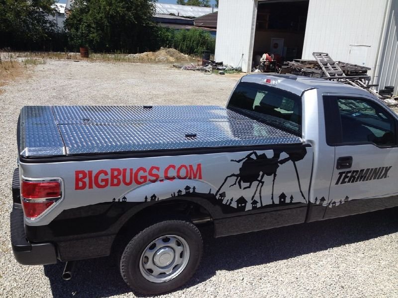 Pest control service truck parked outside a building