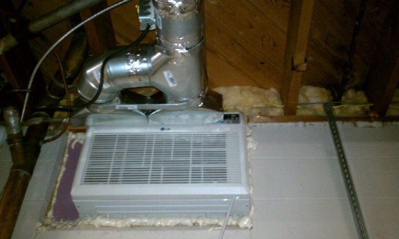 Ductwork and an air handler in an unfinished basement ceiling