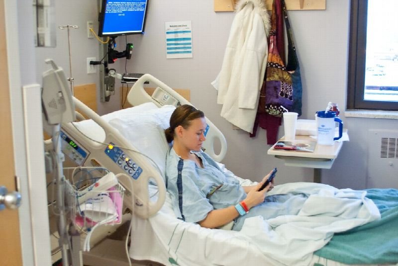Patient in a hospital bed in a patient room