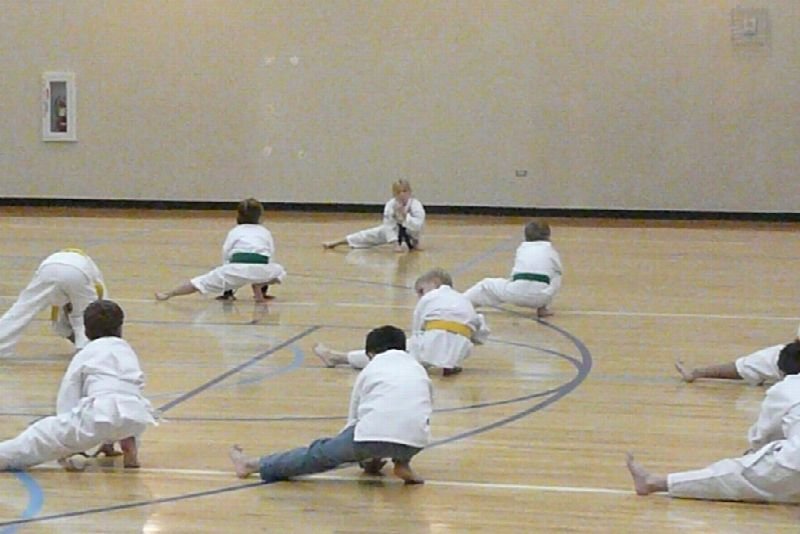 Children practicing karate in a gym