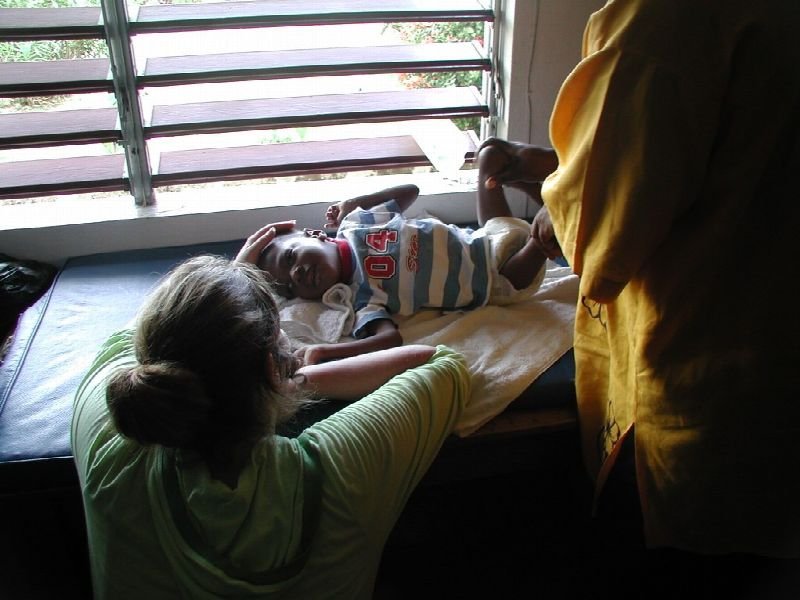 Therapist working with a patient by a window