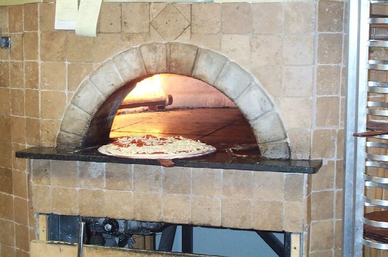 Pizza baking in a brick oven