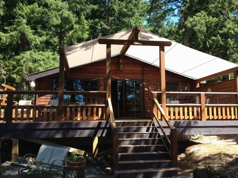 Wooden vacation cabin with a deck among trees