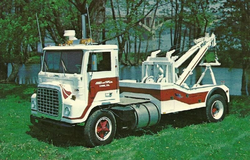 Vintage tow truck parked on grass