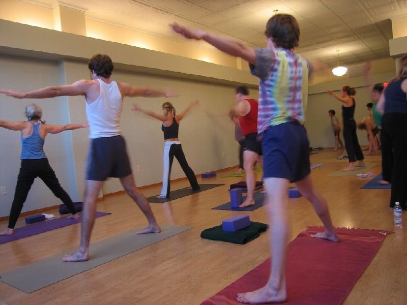 Students holding a yoga pose in a studio class