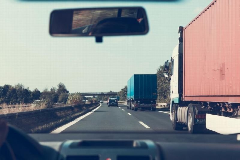 Semi truck on a highway seen from a vehicle cab