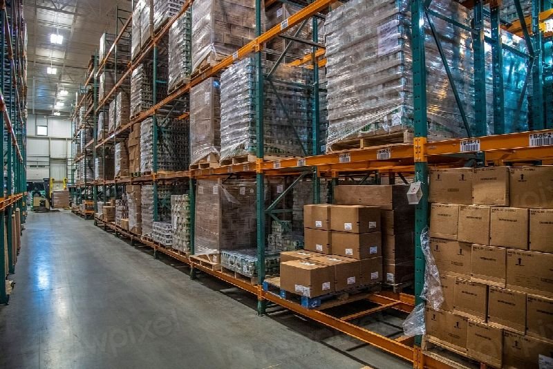 Warehouse aisle with shelving stacked with boxed inventory